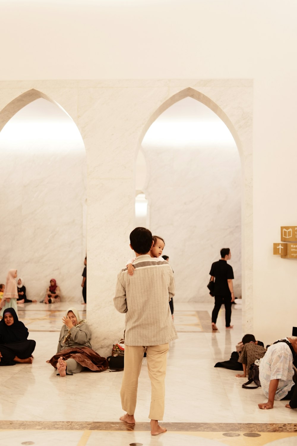 a group of people sitting and standing in a room