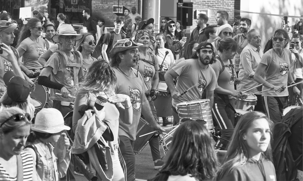 a large group of people walking down a street