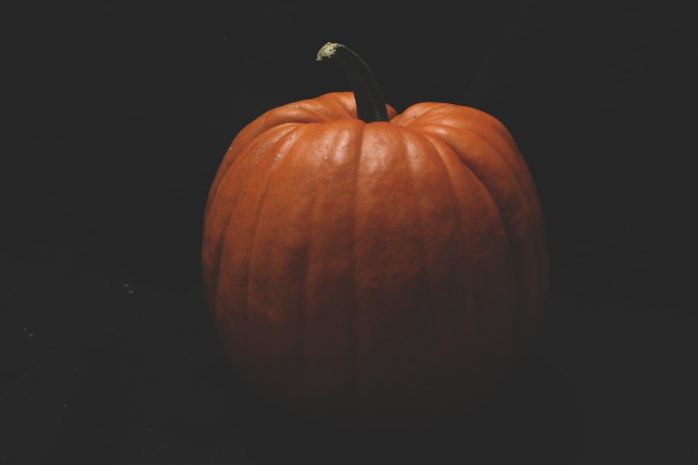 a large orange pumpkin sitting on top of a table
