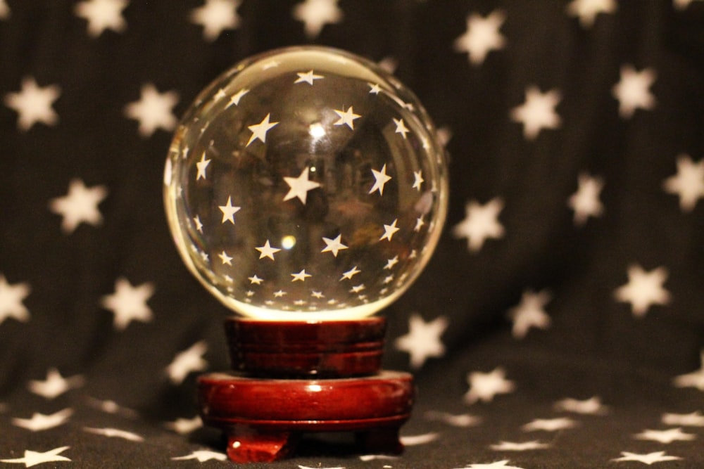 a snow globe sitting on top of a wooden stand