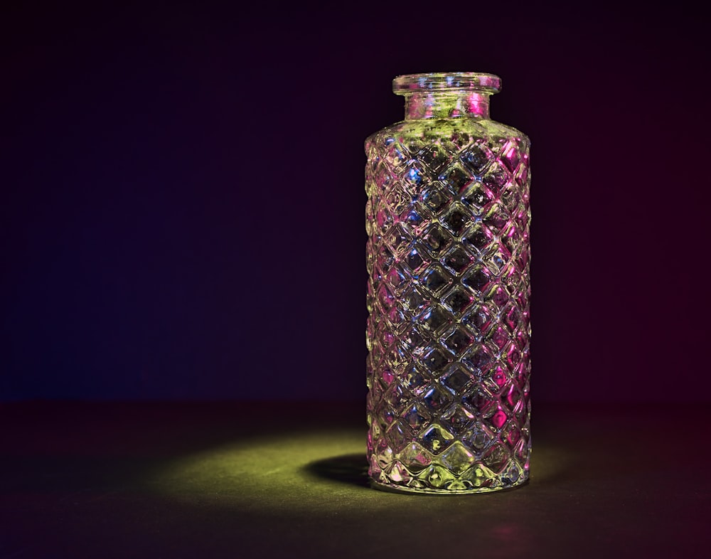 a glass vase sitting on top of a table