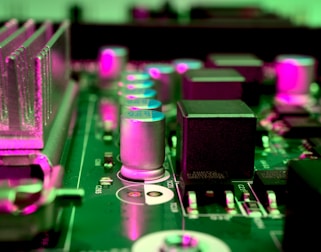 a close up of a computer motherboard with pink lights