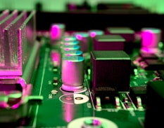 a close up of a computer motherboard with pink lights