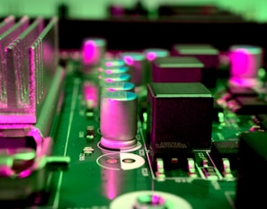 a close up of a computer motherboard with pink lights