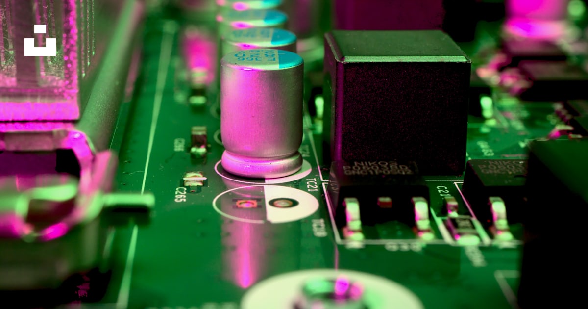 A close up of a computer motherboard with pink lights photo – Free ...