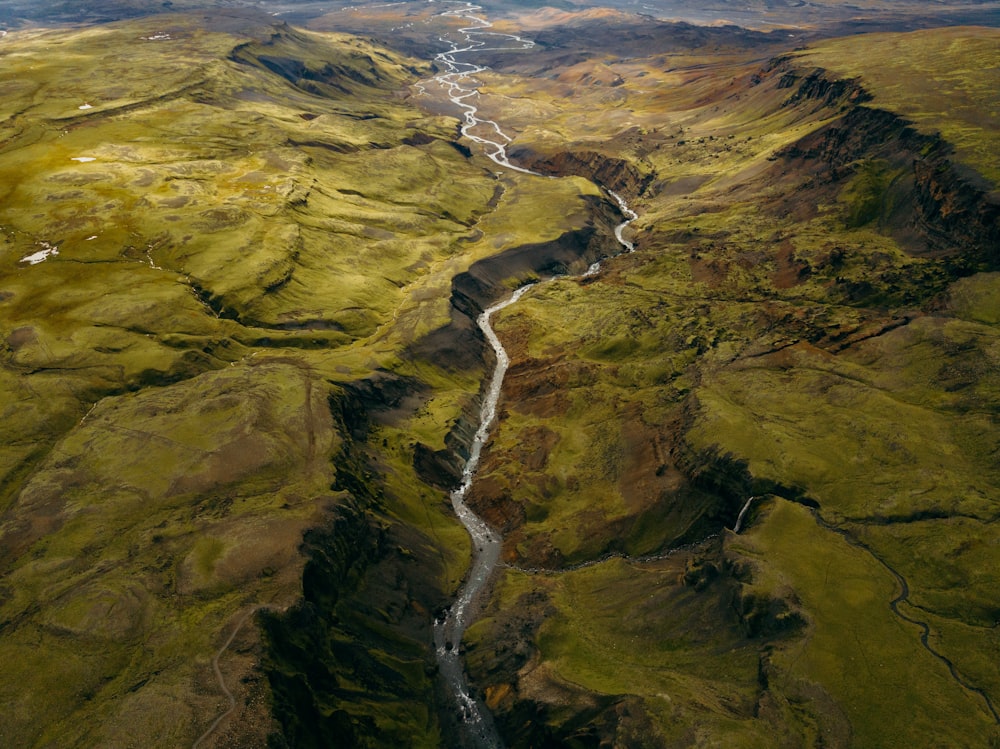 a river running through a lush green valley