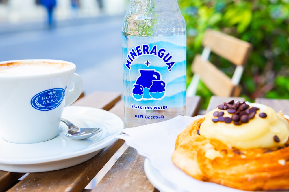 a cup of coffee and a pastry on a table