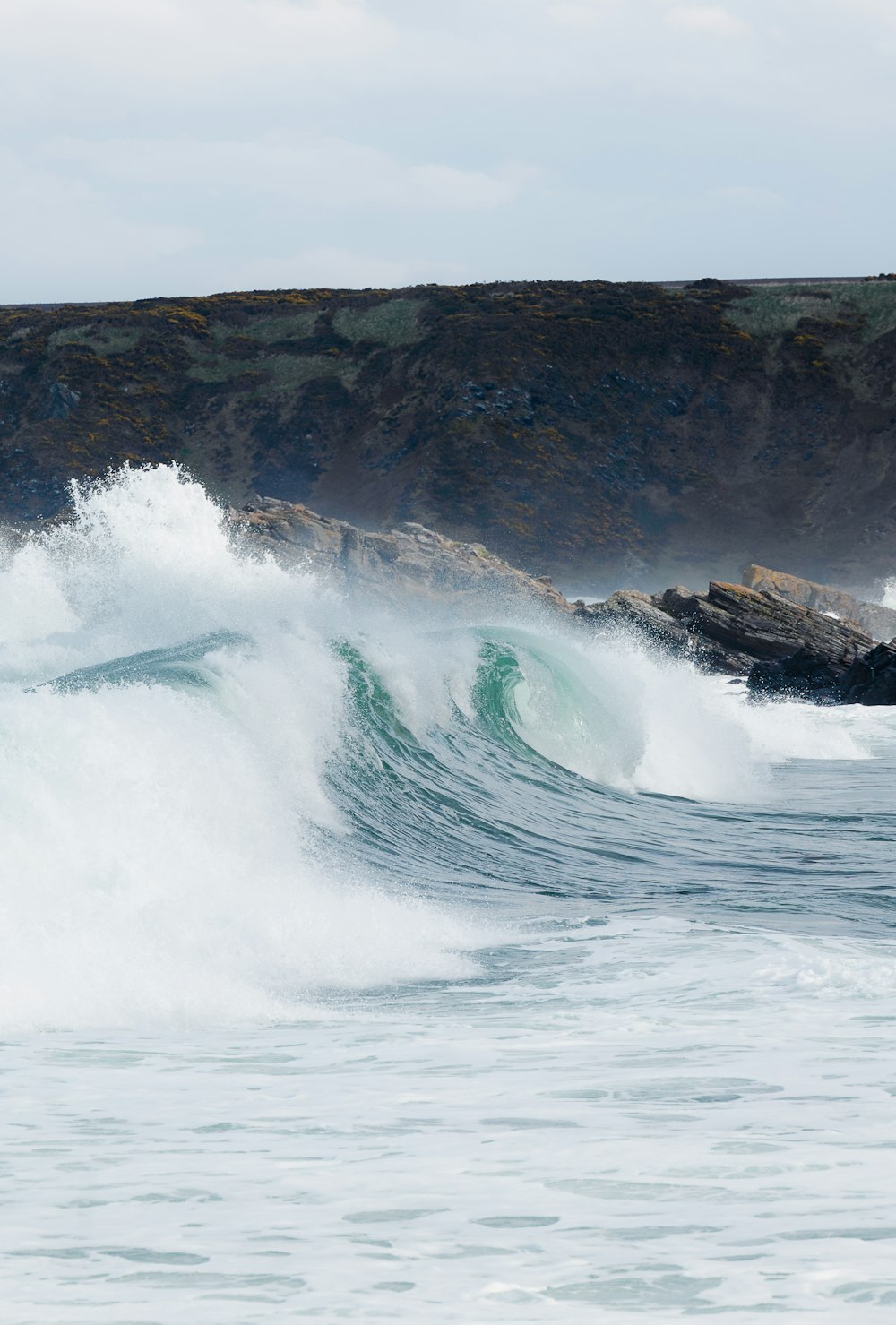 a man riding a wave on top of a surfboard