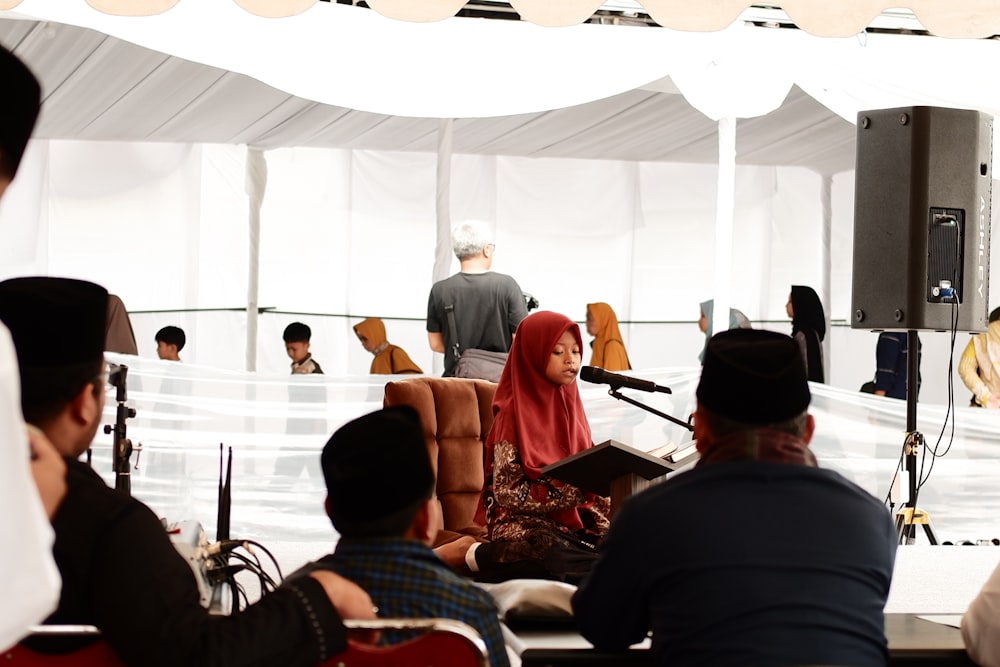 a group of people sitting around a stage