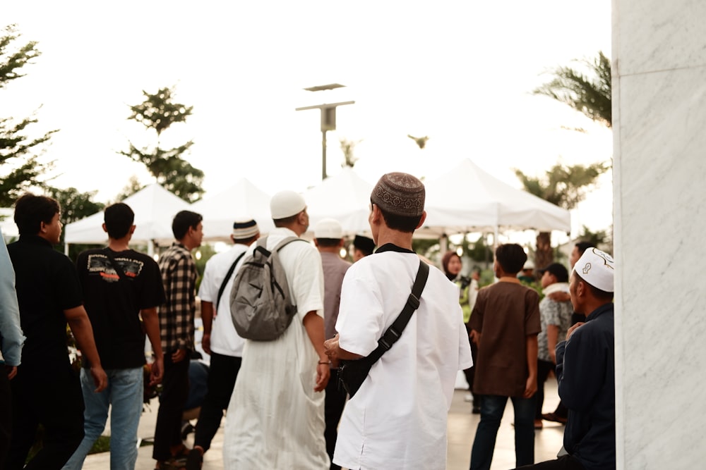 a group of people standing around each other