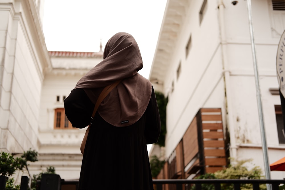 a woman in a burka walking down a street