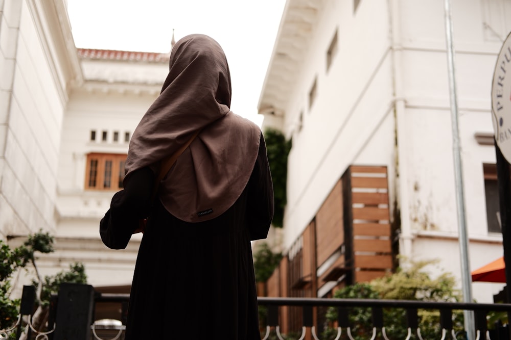 a woman in a nun outfit walking down a street