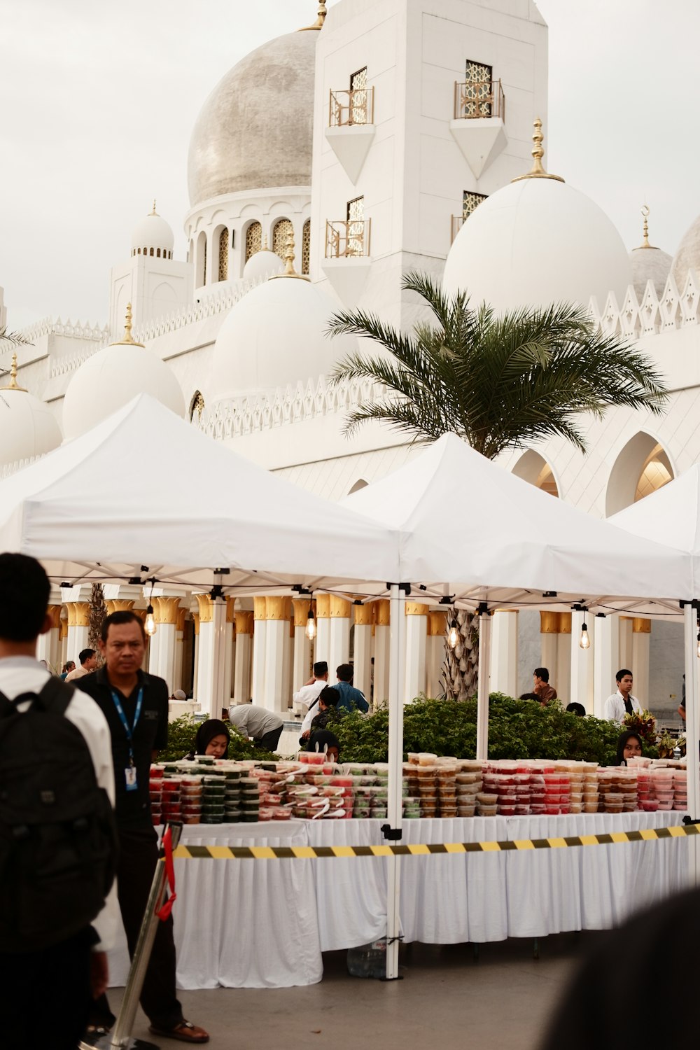 a group of people standing in front of a white building