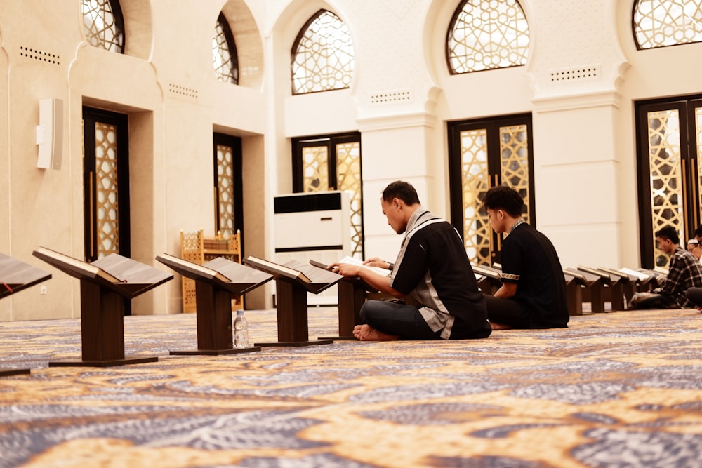 a couple of men sitting on the floor of a room