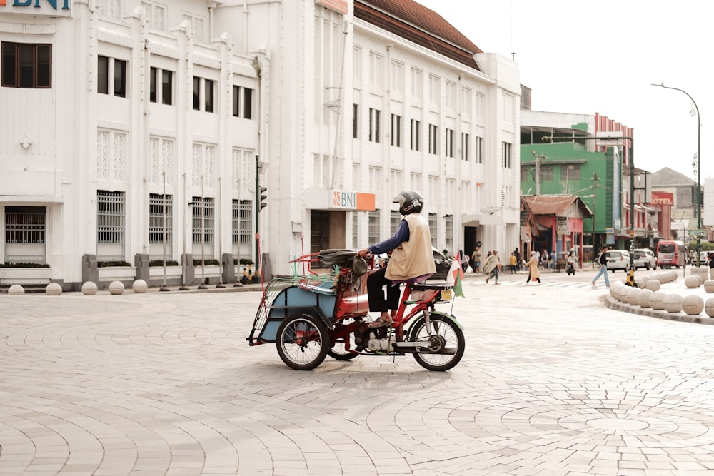 a person riding a bike with a side car attached to it