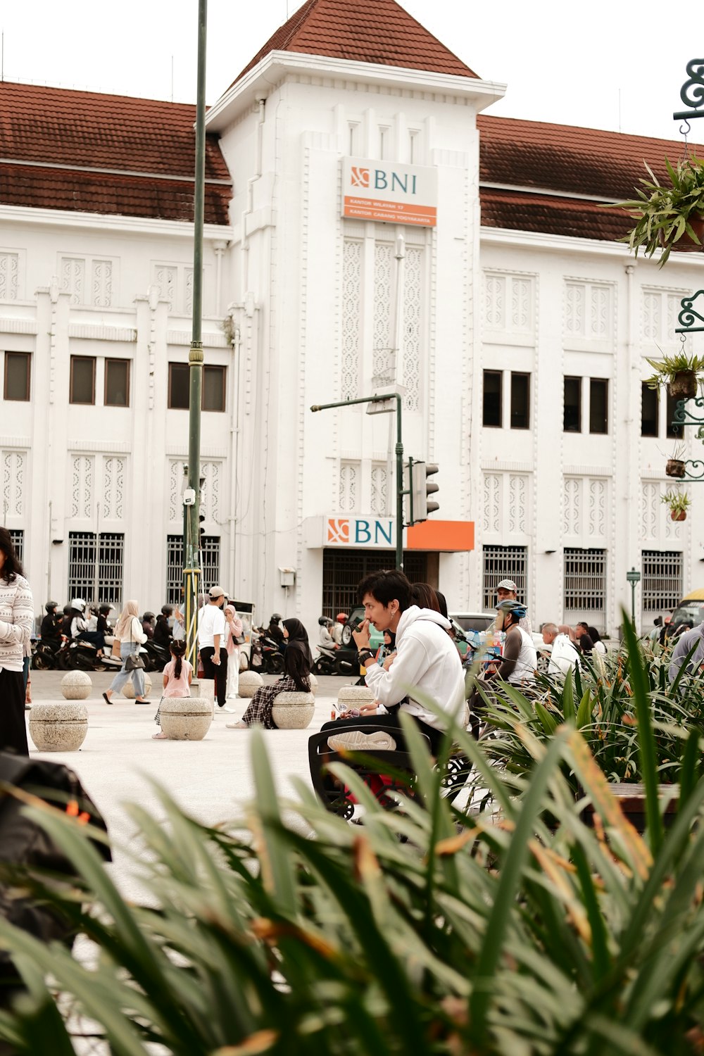 a man sitting on a bench in front of a building