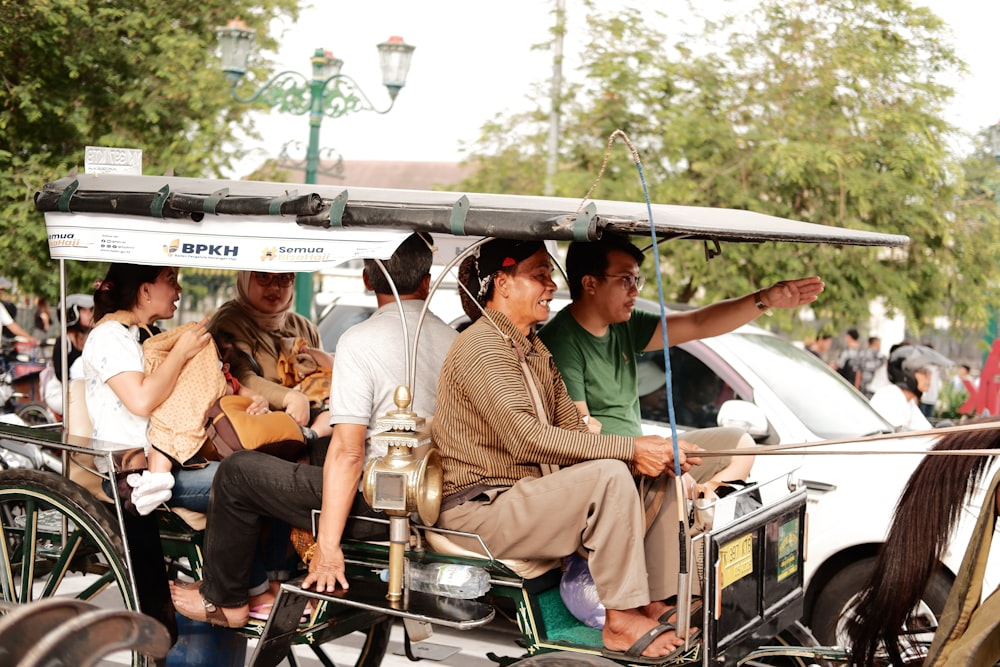 a group of people riding in a horse drawn carriage