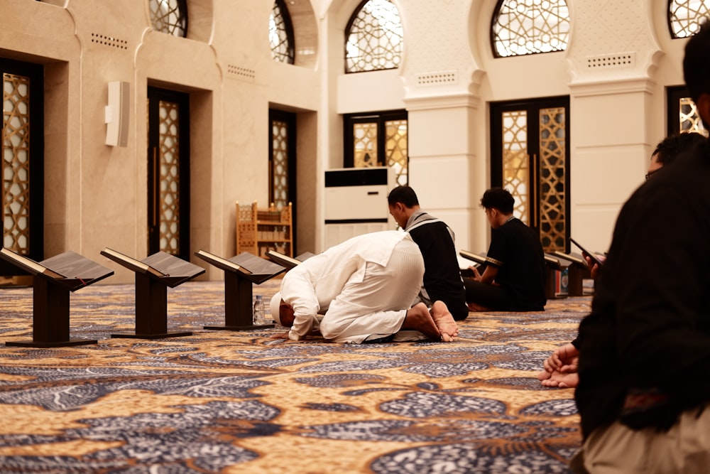 a group of men sitting on the floor in a room