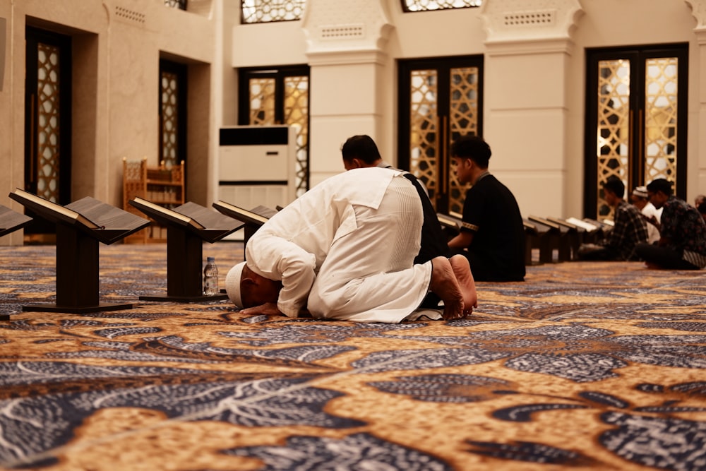 a man sitting on the floor in a room