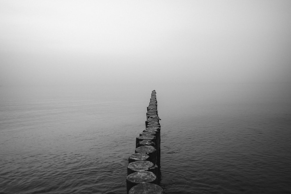 a black and white photo of a long pier