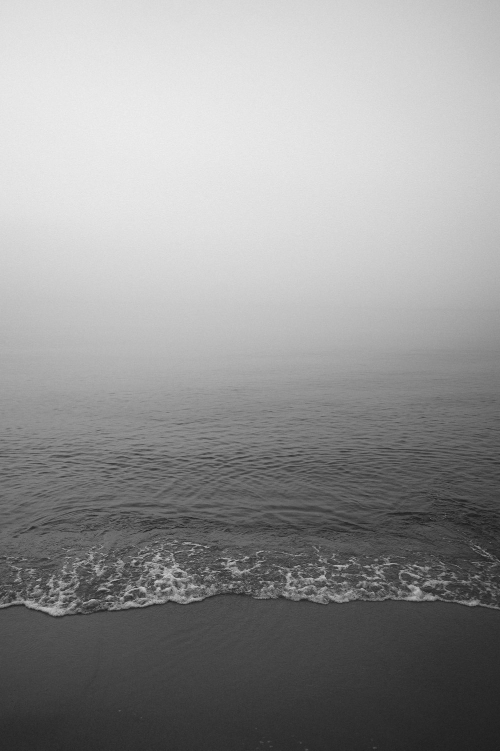 a black and white photo of the ocean