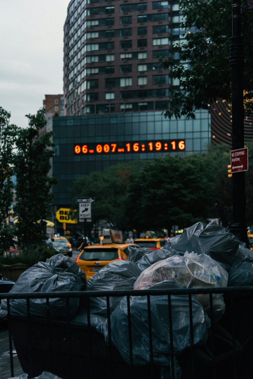 a bunch of trash bags sitting on the side of a road