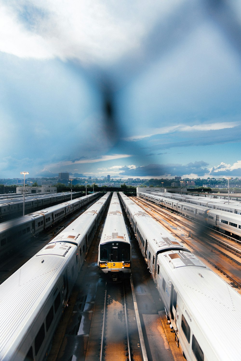 a train yard with several trains on the tracks