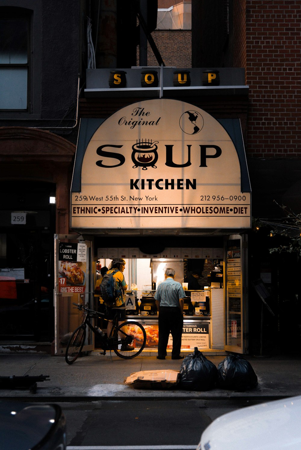 a man standing in the doorway of a kitchen