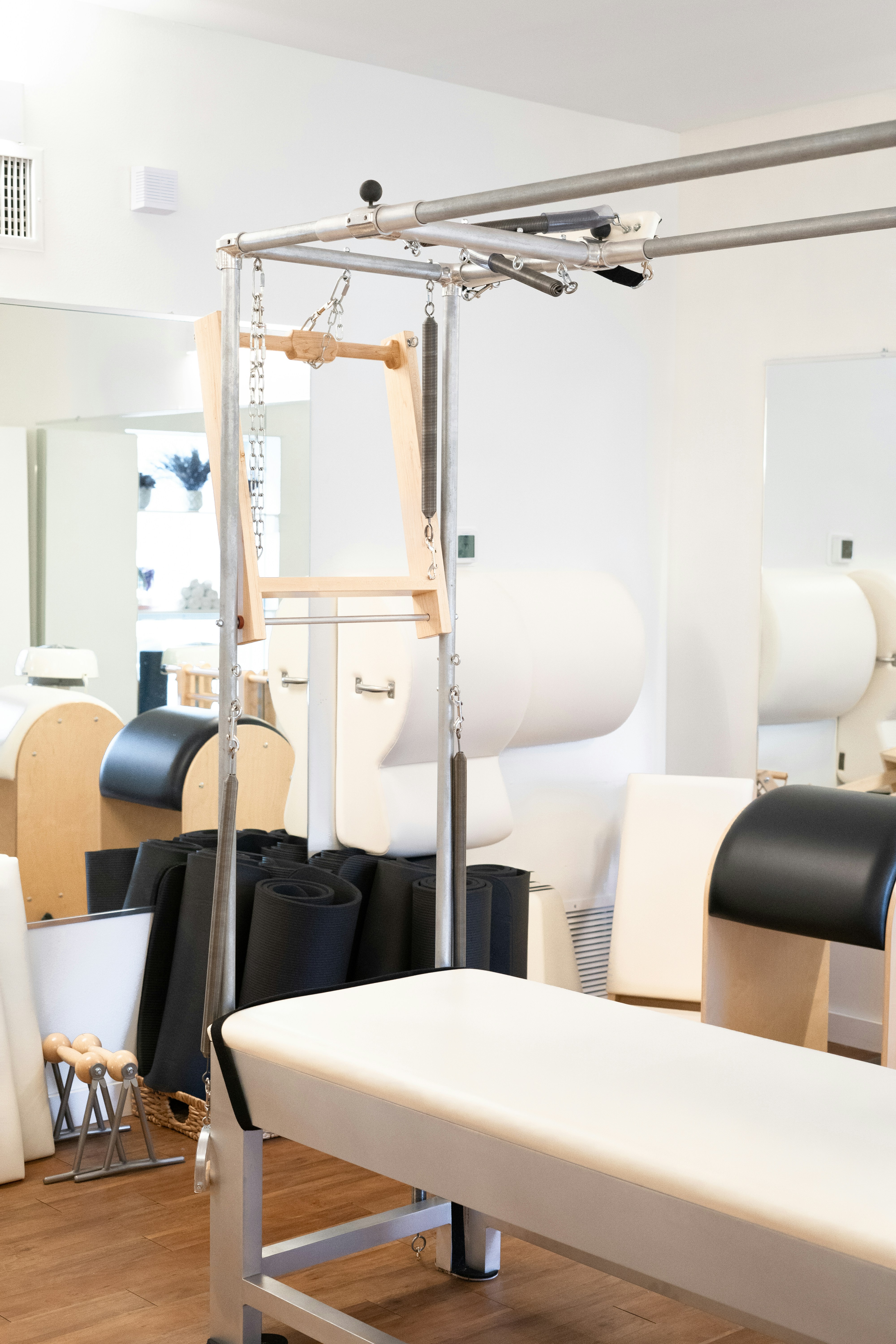 a white bench sitting in front of a mirror