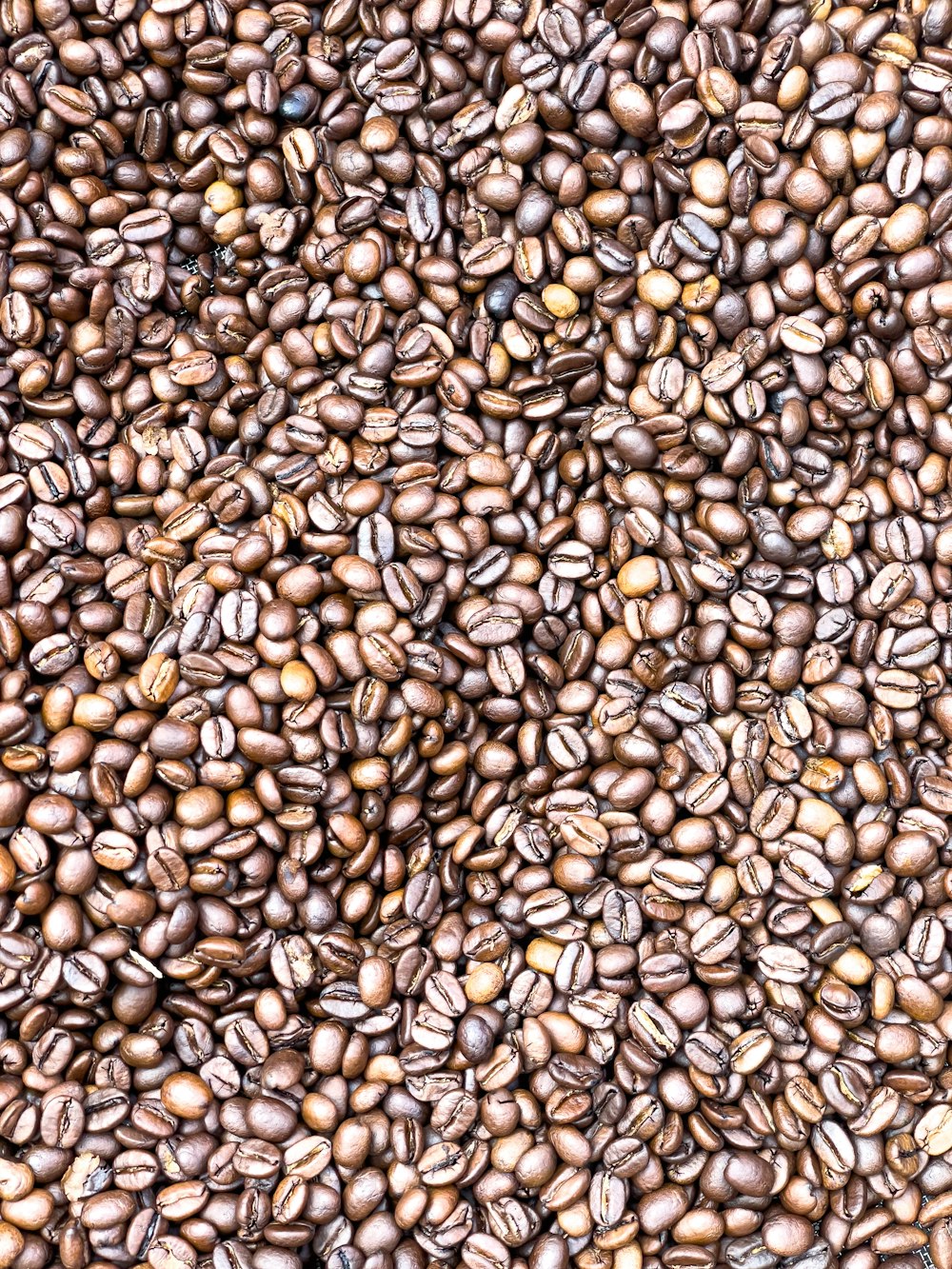 a pile of coffee beans is shown in this image