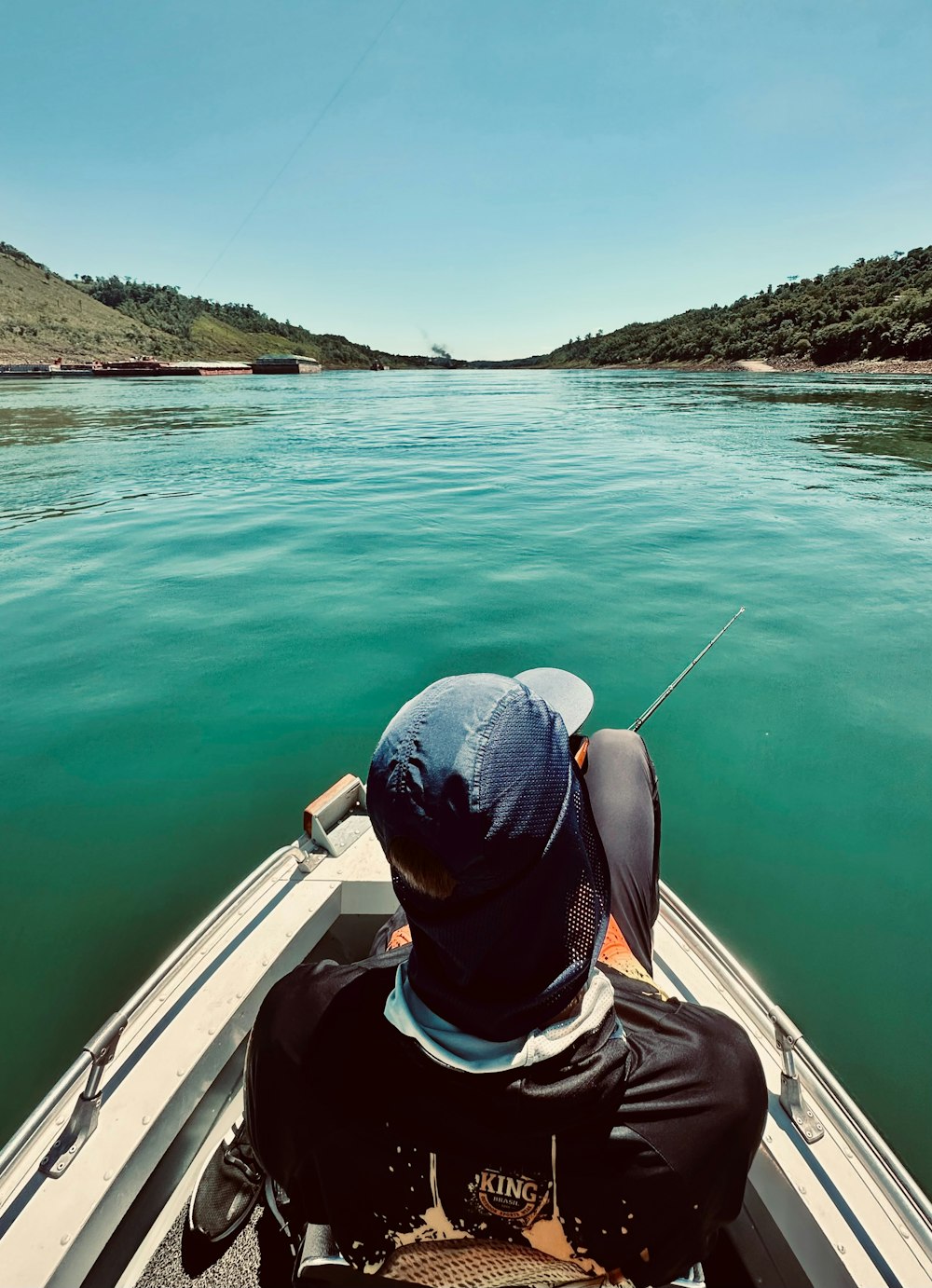 a person in a boat fishing on a lake