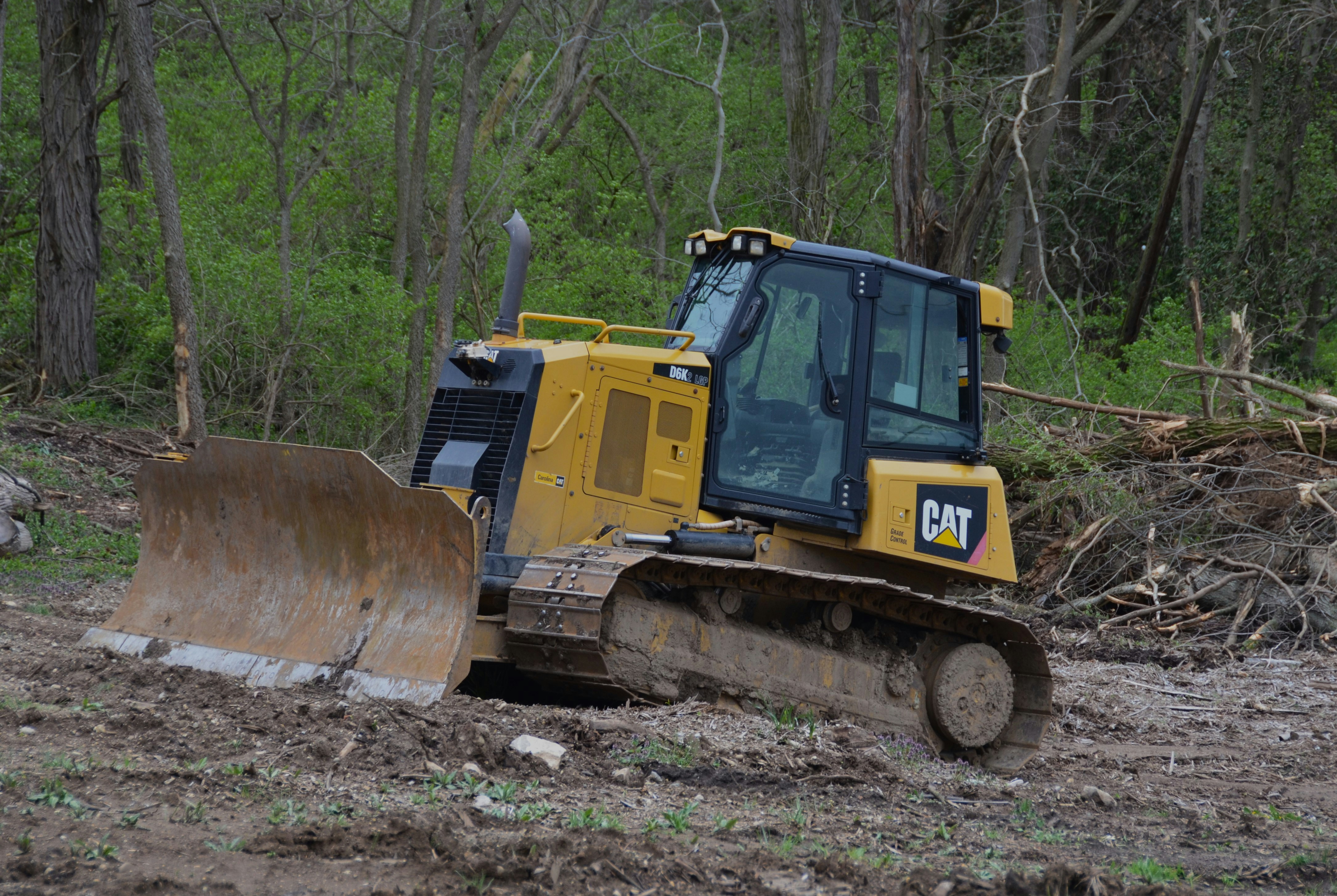 bulldozer shaping a slope for land grading - land grading services