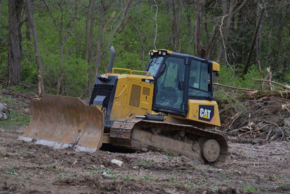 a bulldozer digging through a muddy field