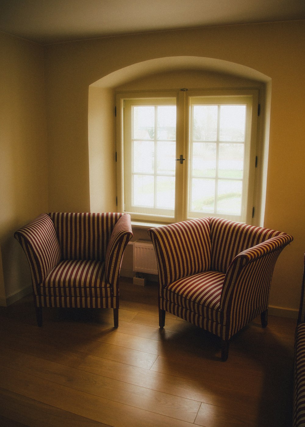 a couple of chairs sitting in front of a window