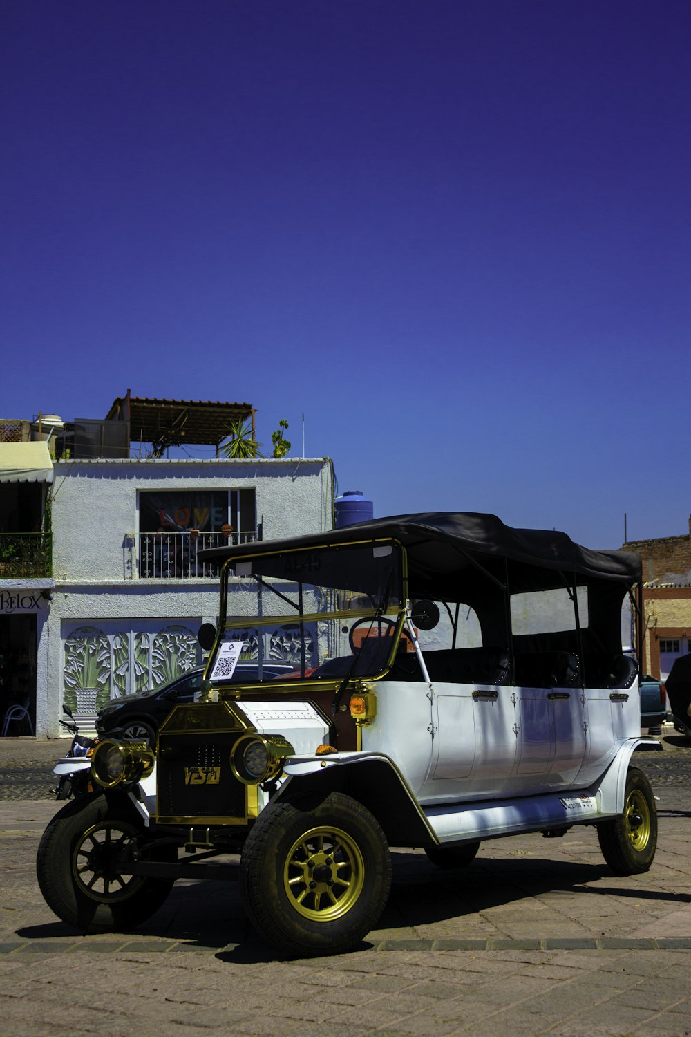 an old car parked in front of a building