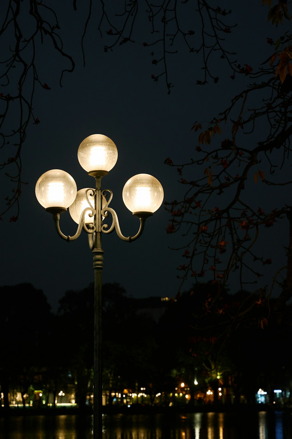 a lamp post with four lights on top of it