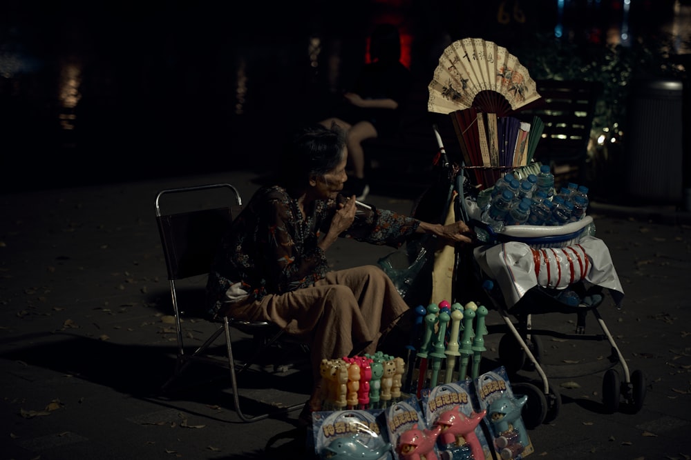 a man sitting in a chair next to a pile of candy