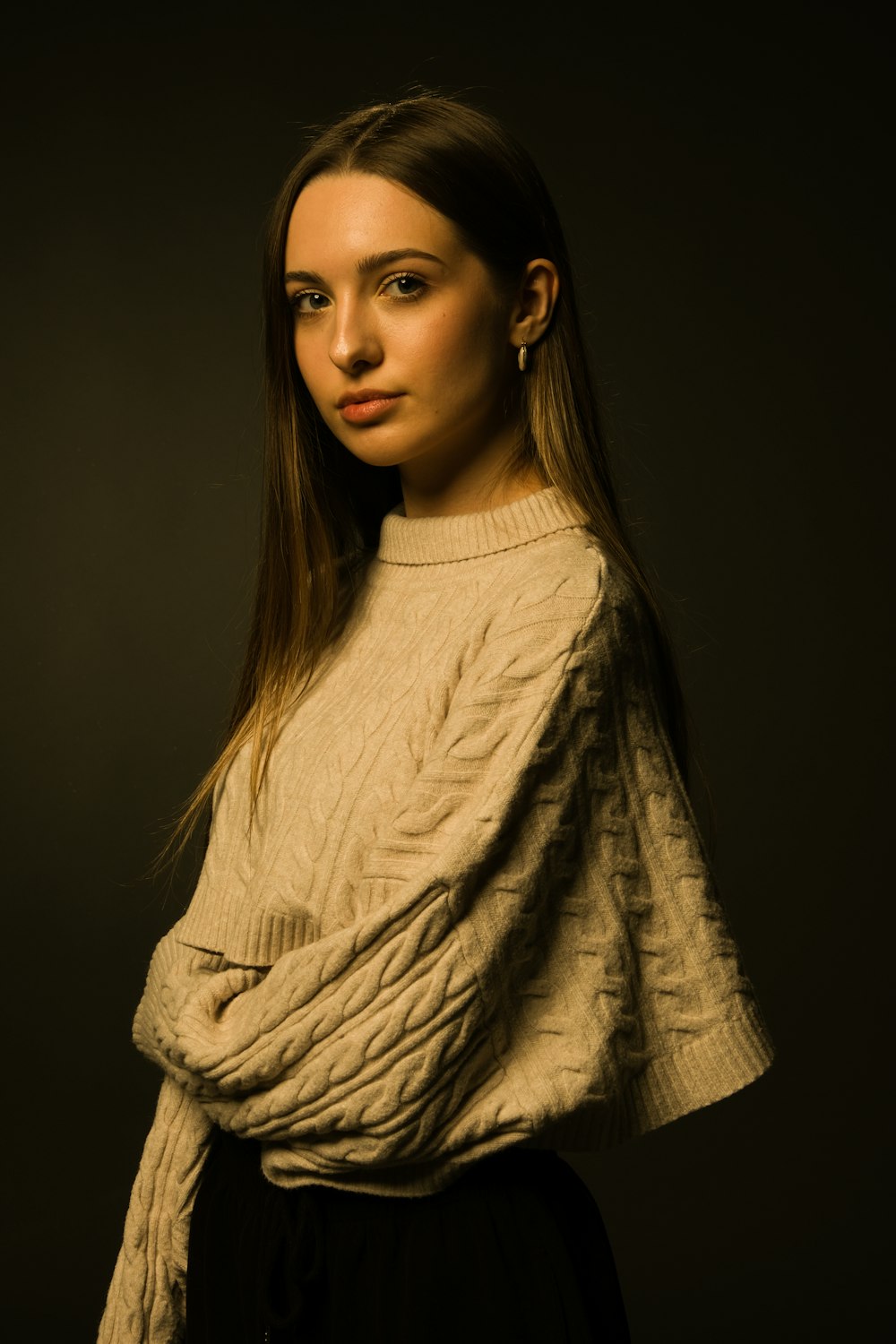 a woman in a sweater posing for a picture