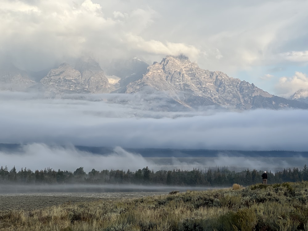 a large mountain covered in clouds and fog