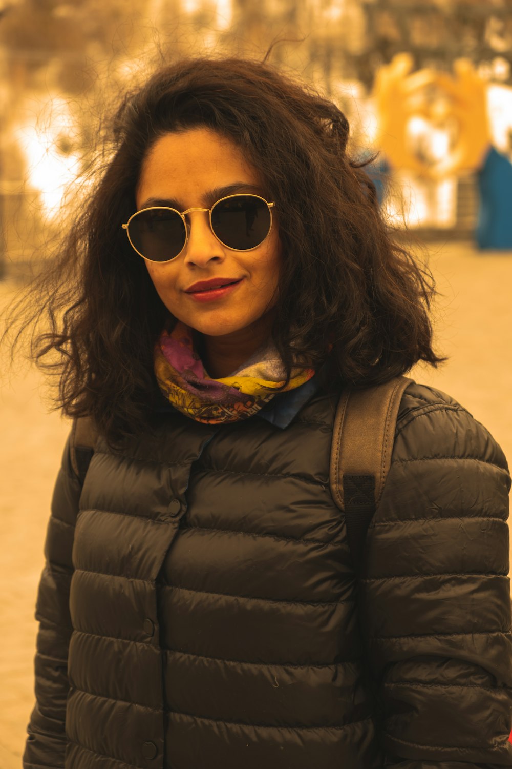 a woman wearing sunglasses and a jacket