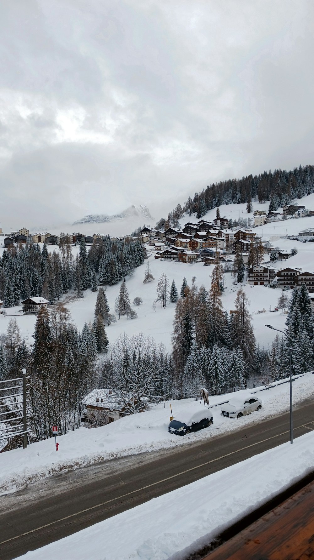 a view of a snowy mountain town from a highway