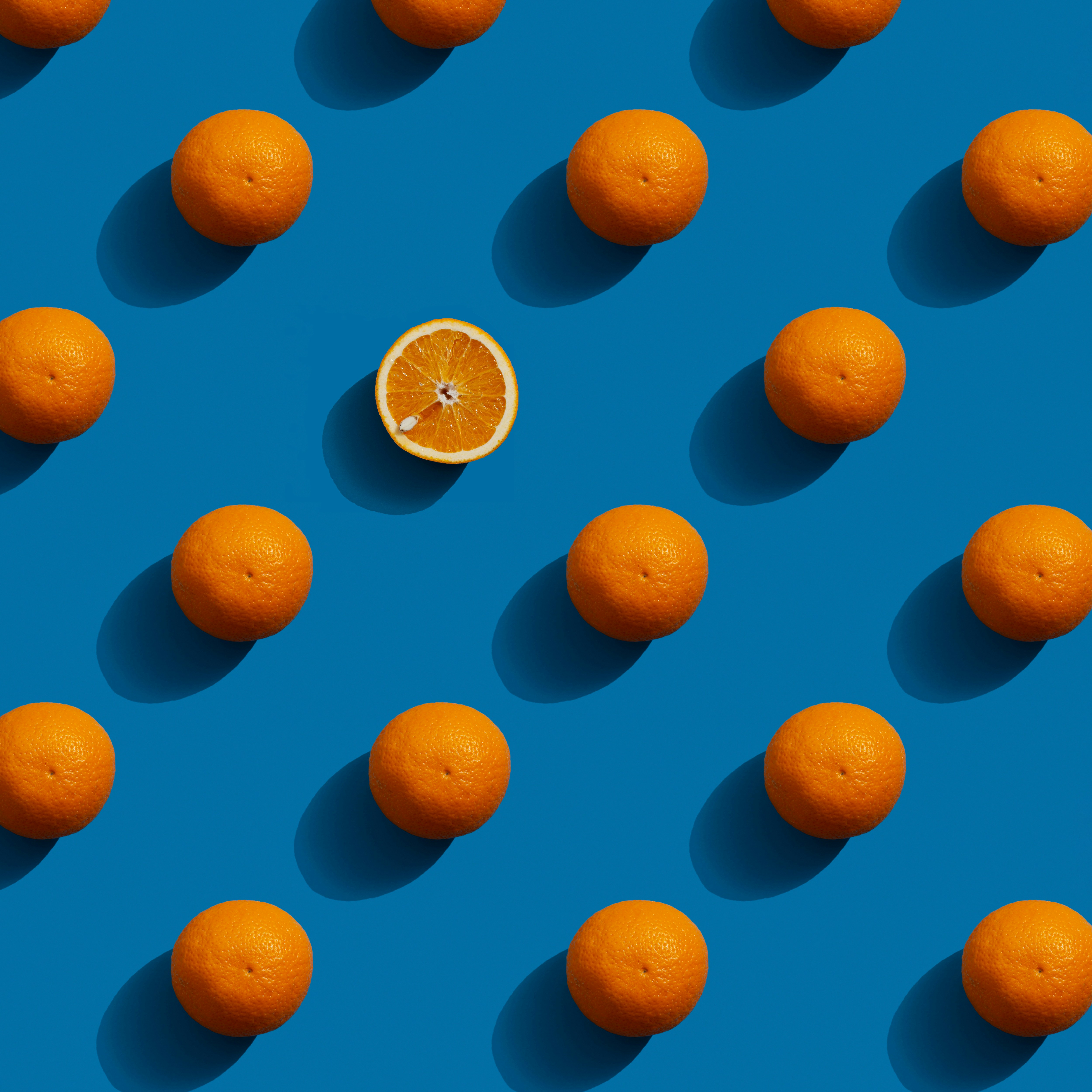 a group of oranges sitting on top of a blue surface