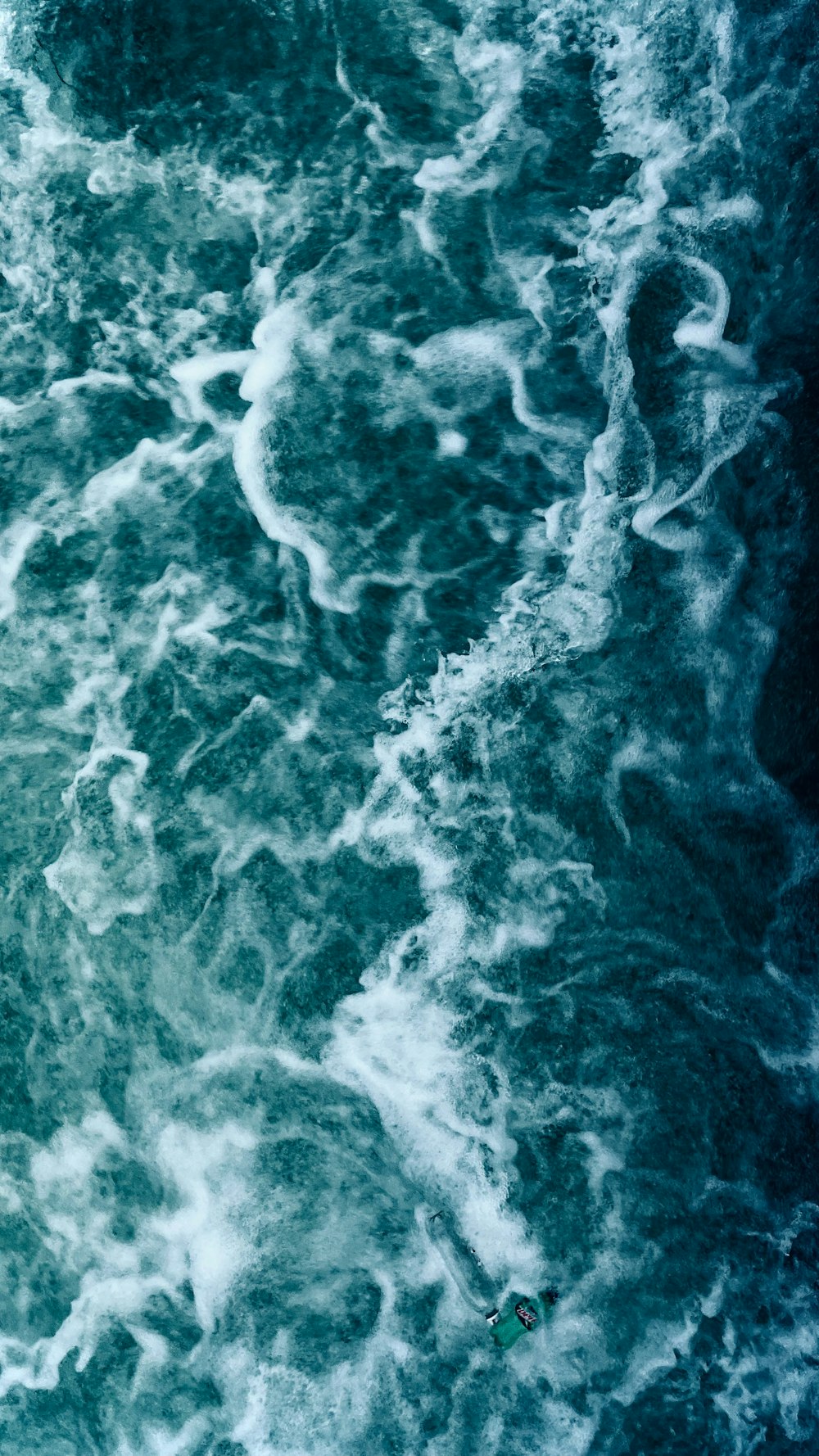 a man riding a surfboard on top of a wave in the ocean