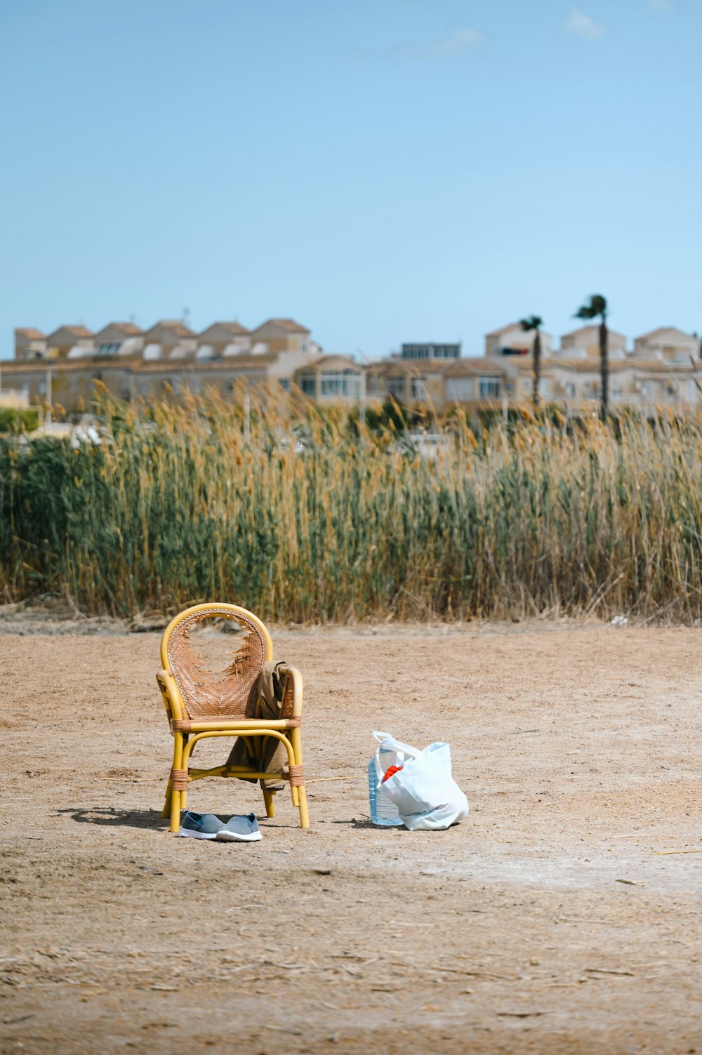a chair and a bag sitting on a beach