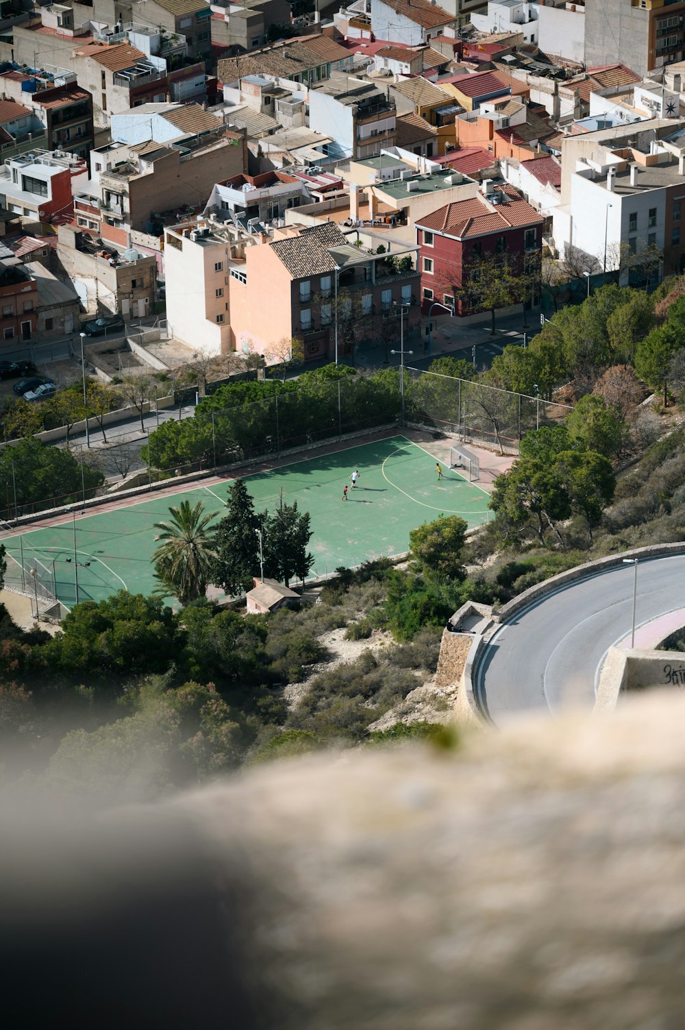 an aerial view of a tennis court in a city