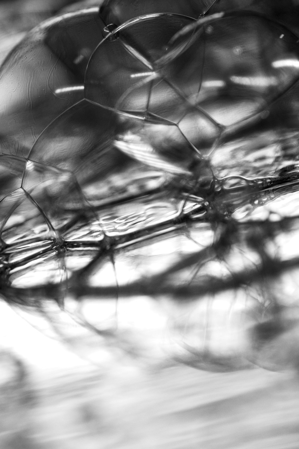 a black and white photo of a wire fence