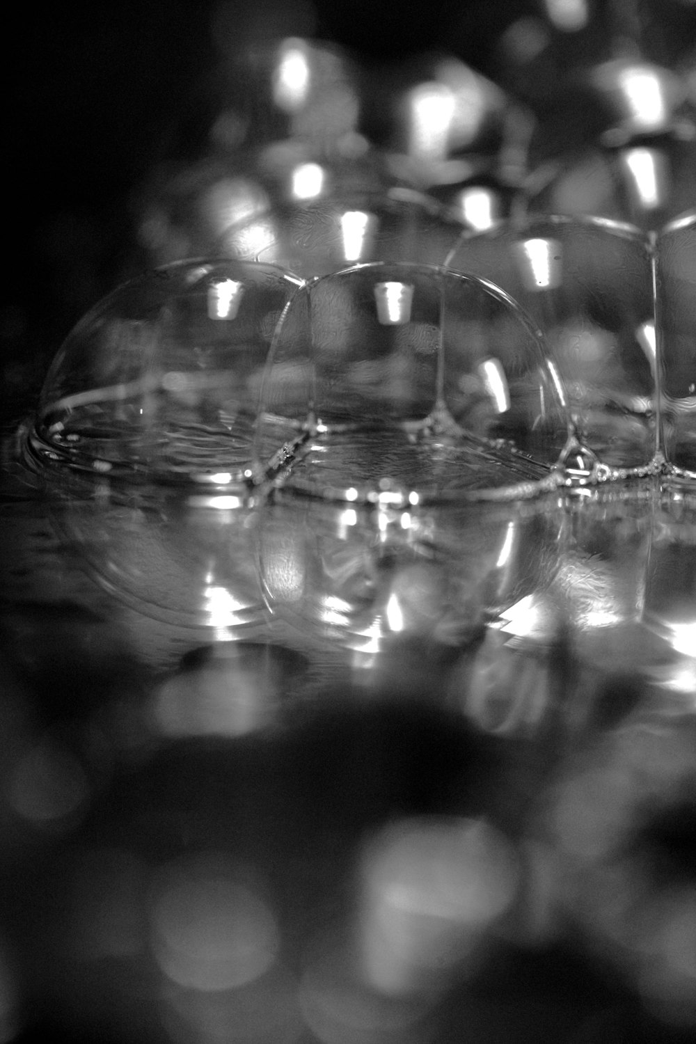 a black and white photo of wine glasses