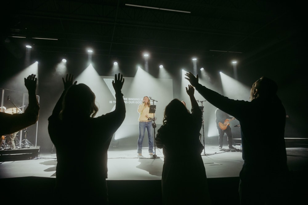 a group of people standing on top of a stage