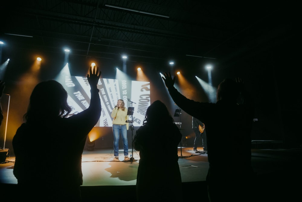 a group of people standing on top of a stage