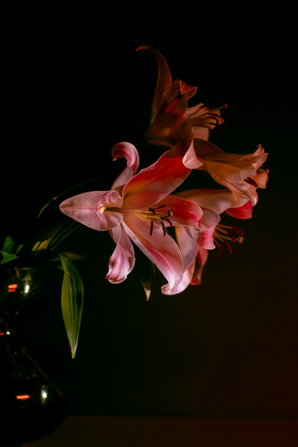 a vase filled with pink flowers on top of a table